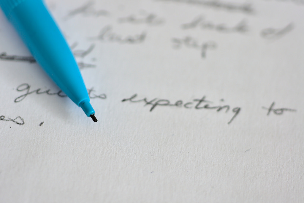 Close-up image of a mechanical pencil resting on hand-written notes.