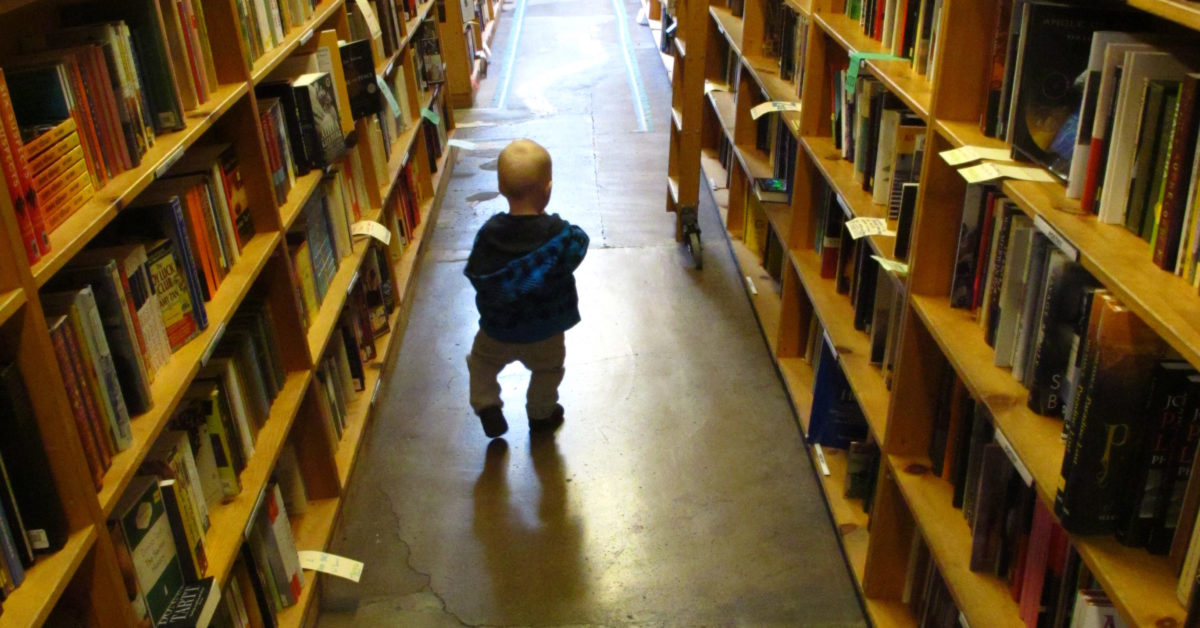 toddler in a bookstore - kids bookstores in KS and MO