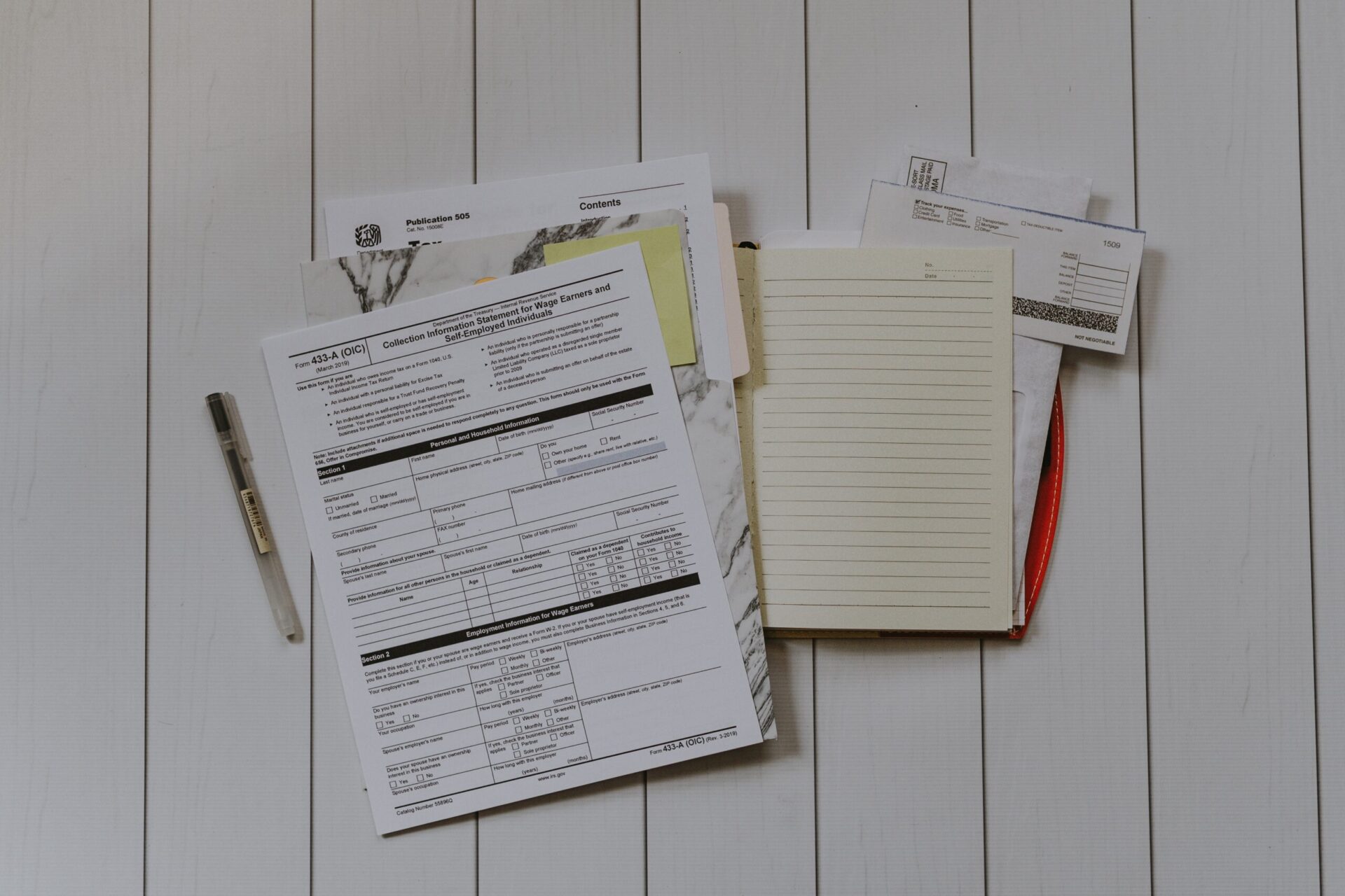 A top view of a pile of tax documents on a table.