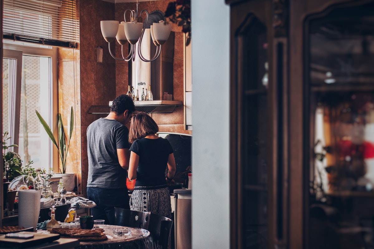 Couple cooking together in their kitchen.