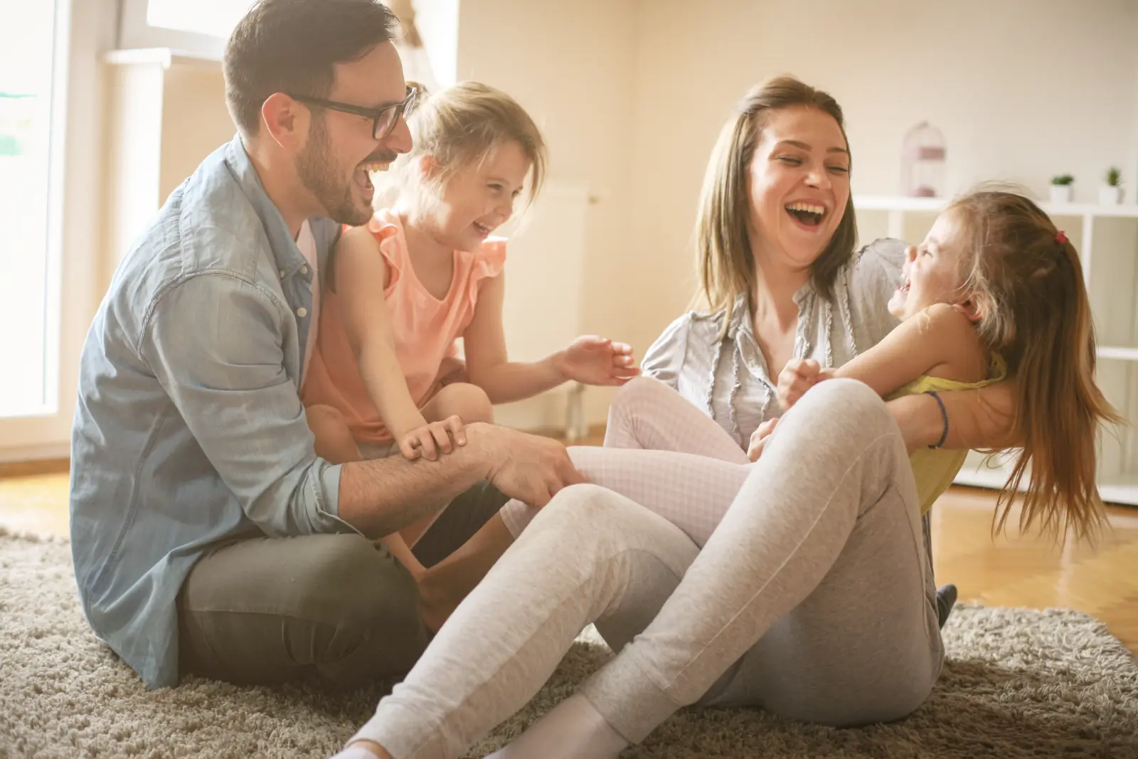 Stay Involved Post-Adoption - A loving family playing on the floor. Our resources support meaningful connections beyond adoption.