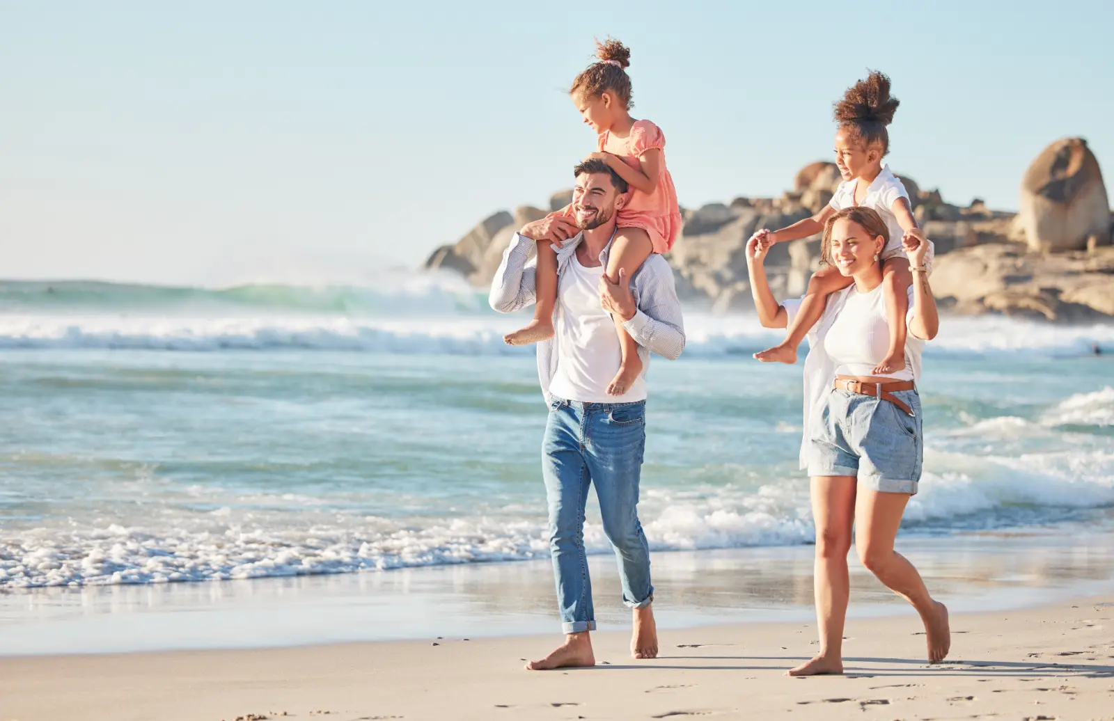 Contact Frequencies in Adoption Agreements: Explore a harmonious family journey with parents and kids enjoying a beach stroll.