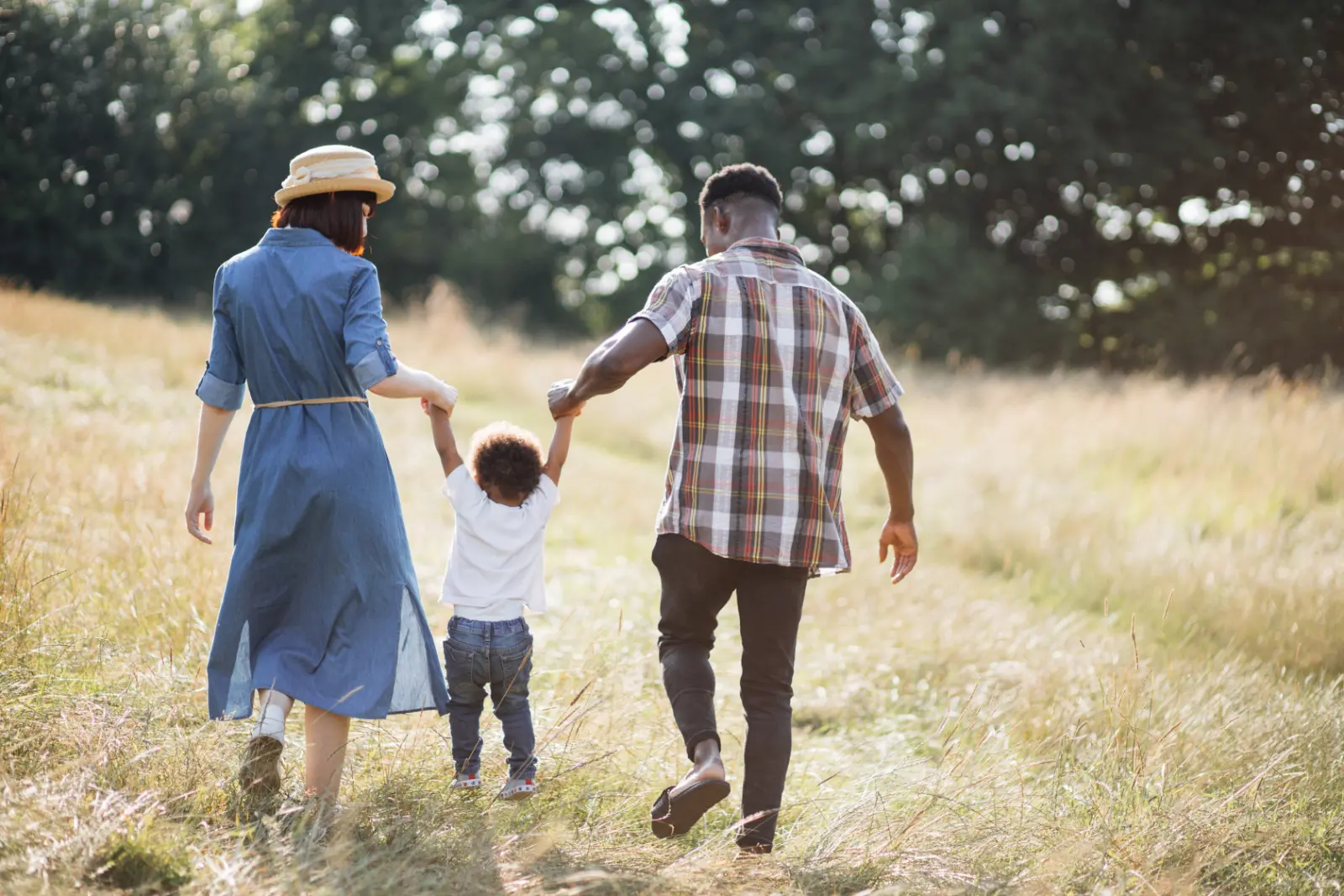 Parents walking with toddler outdoors - Trust us to enforce post-adoption contact agreements seamlessly. Expert guidance for a secure adoption journey. Your peace of mind matters.