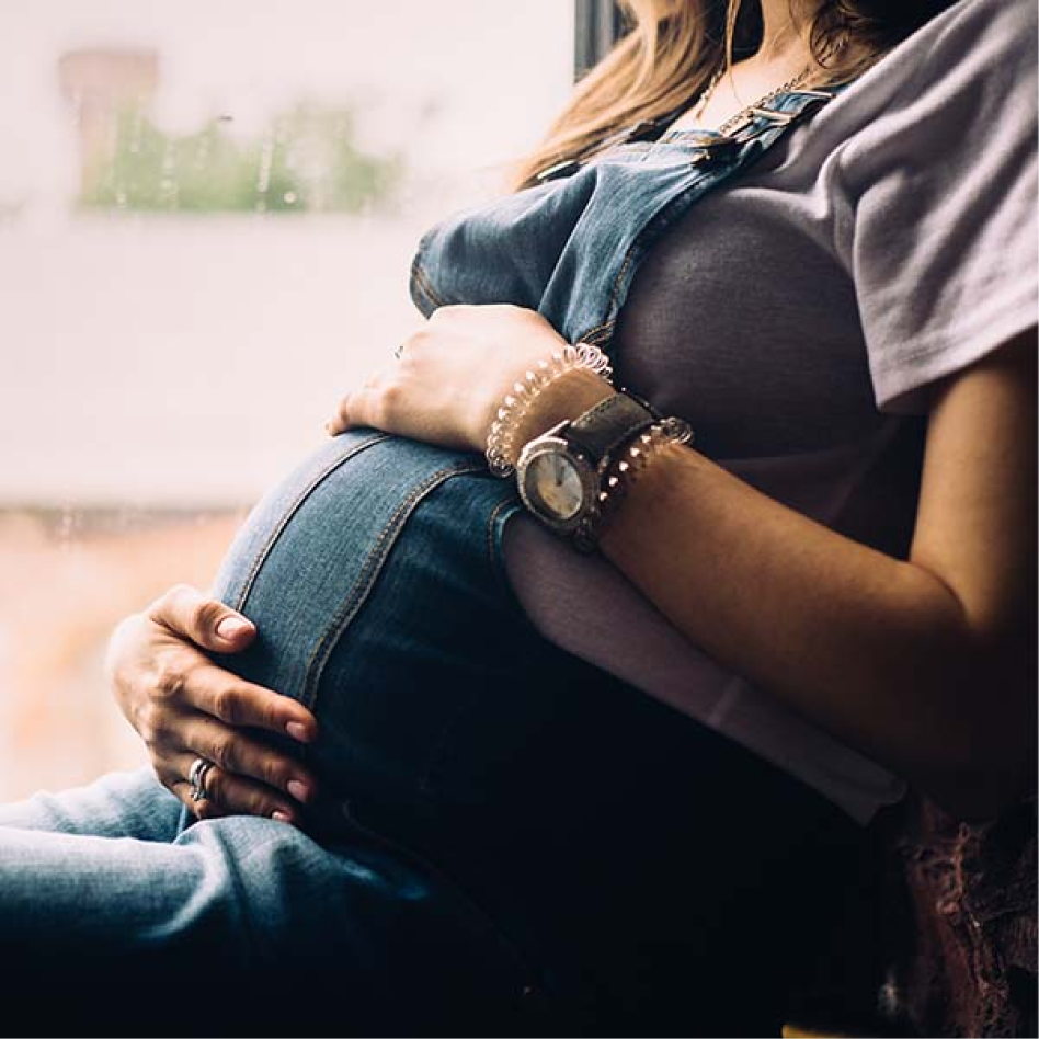 pregnant woman looking at pregnancy test