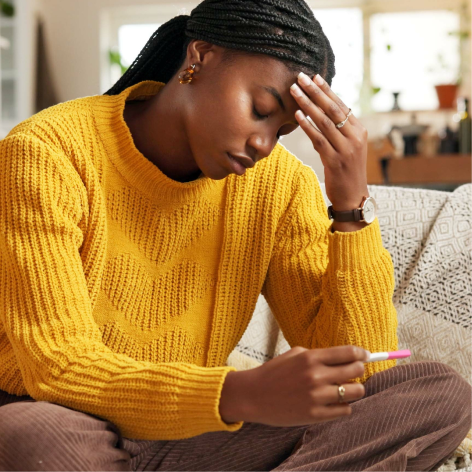 pregnant woman looking at pregnancy test