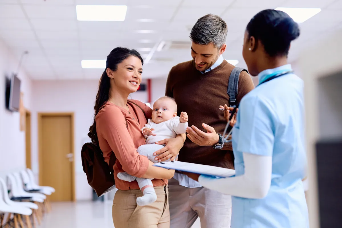 Adoptive family meeting their newborn with hospital staff present